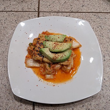 Kimchi with pan-seared tempeh and avocado.