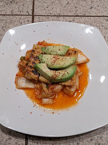 Kimchi with pan-seared tempeh and avocado.