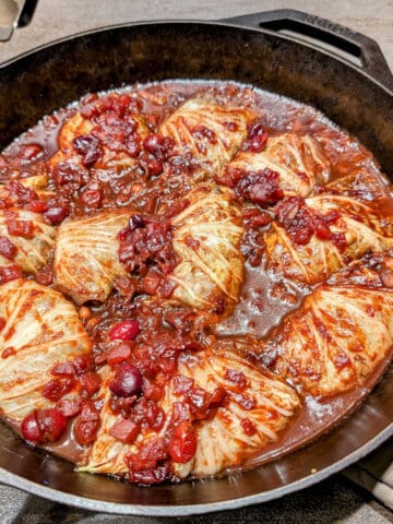 Cabbage stuffed with black eyed peas, topped with cranberry sauce