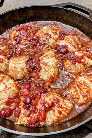 Cabbage stuffed with black eyed peas, topped with cranberry sauce