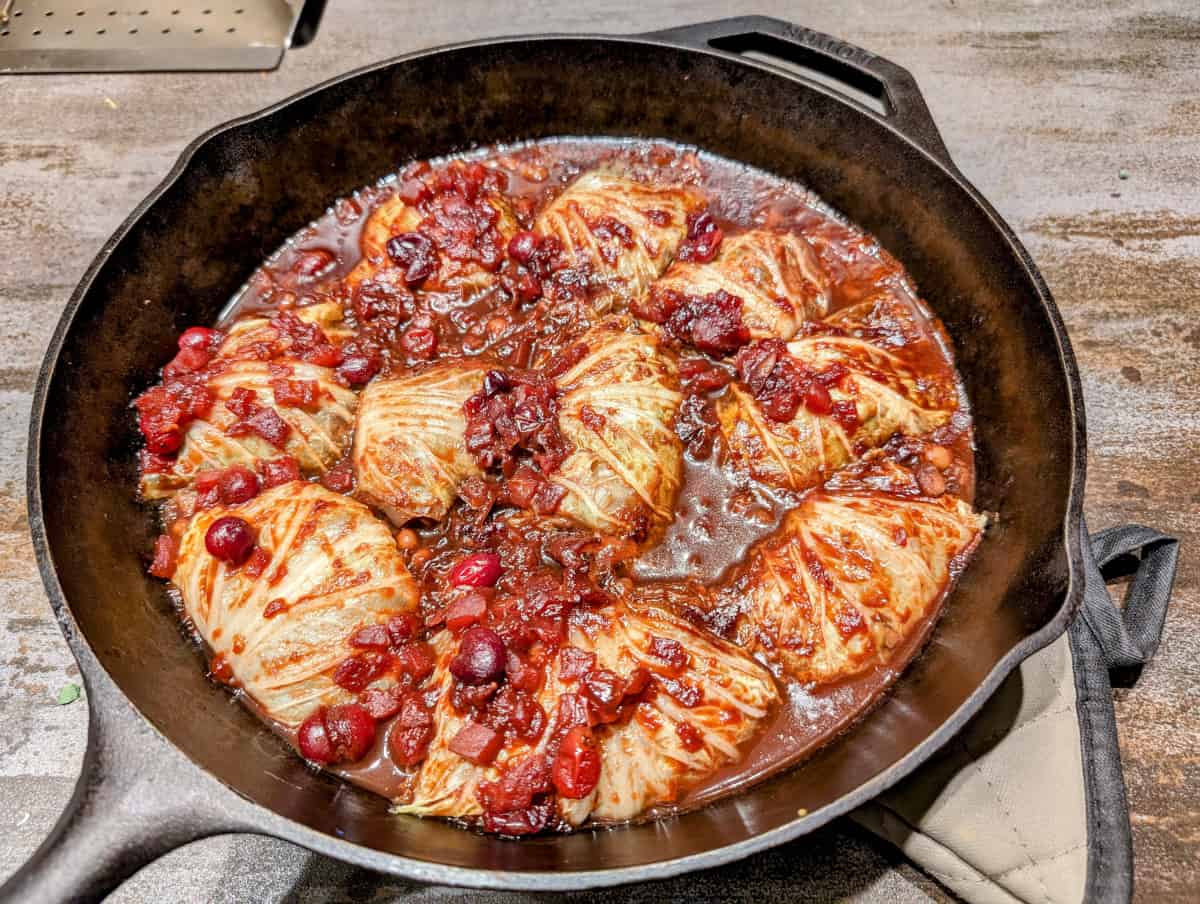 Cabbage stuffed with black eyed peas, topped with cranberry sauce