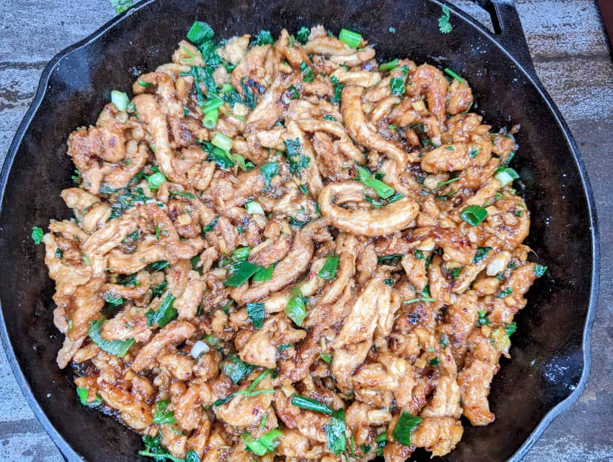 Mongolian soy curls completely mixed with greens and sauce.