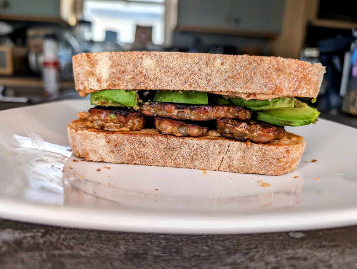 Smoked Tempeh Sandwich with Avocado, up close from the side.