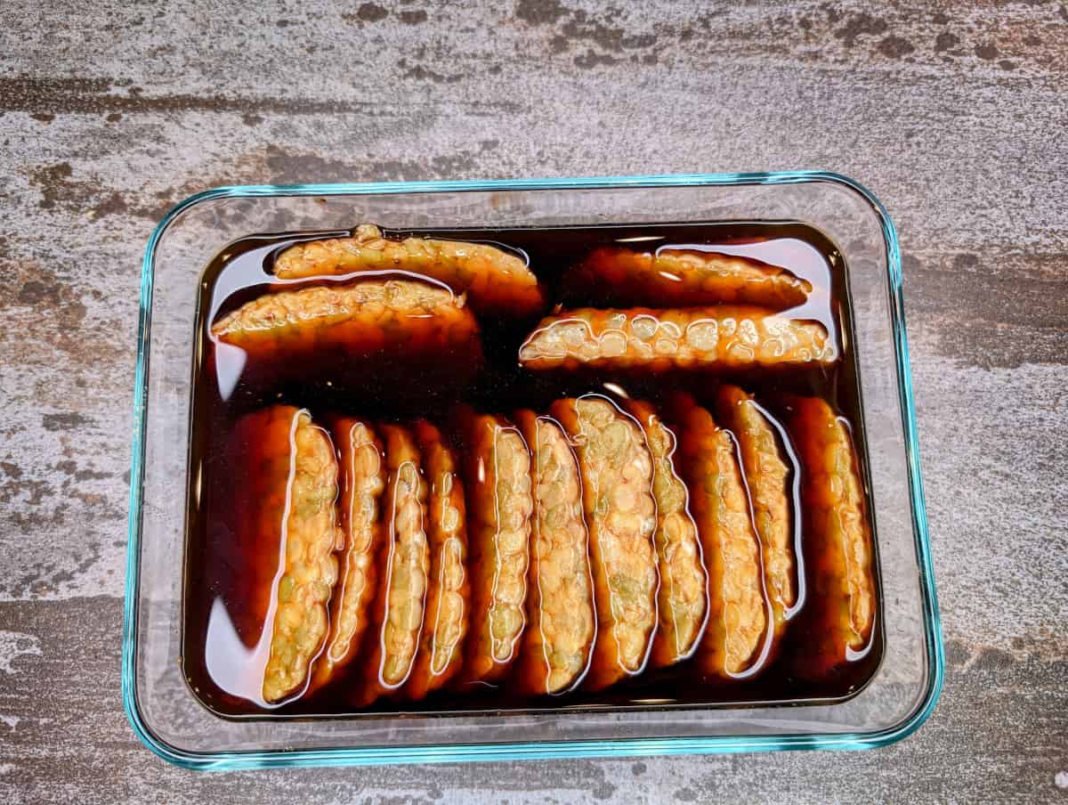 Smoked Tempeh Sandwich with Avocado, pour the marinade over the tempeh.