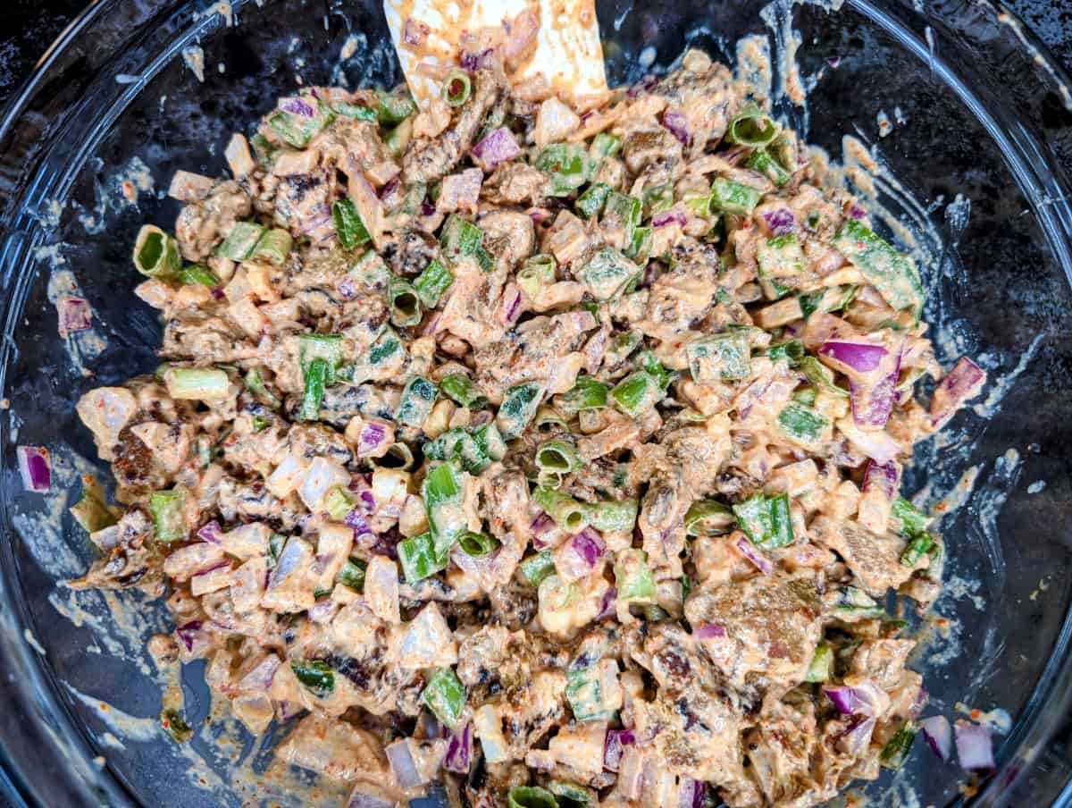 Seitan tahini salad with onions and jalapeños.