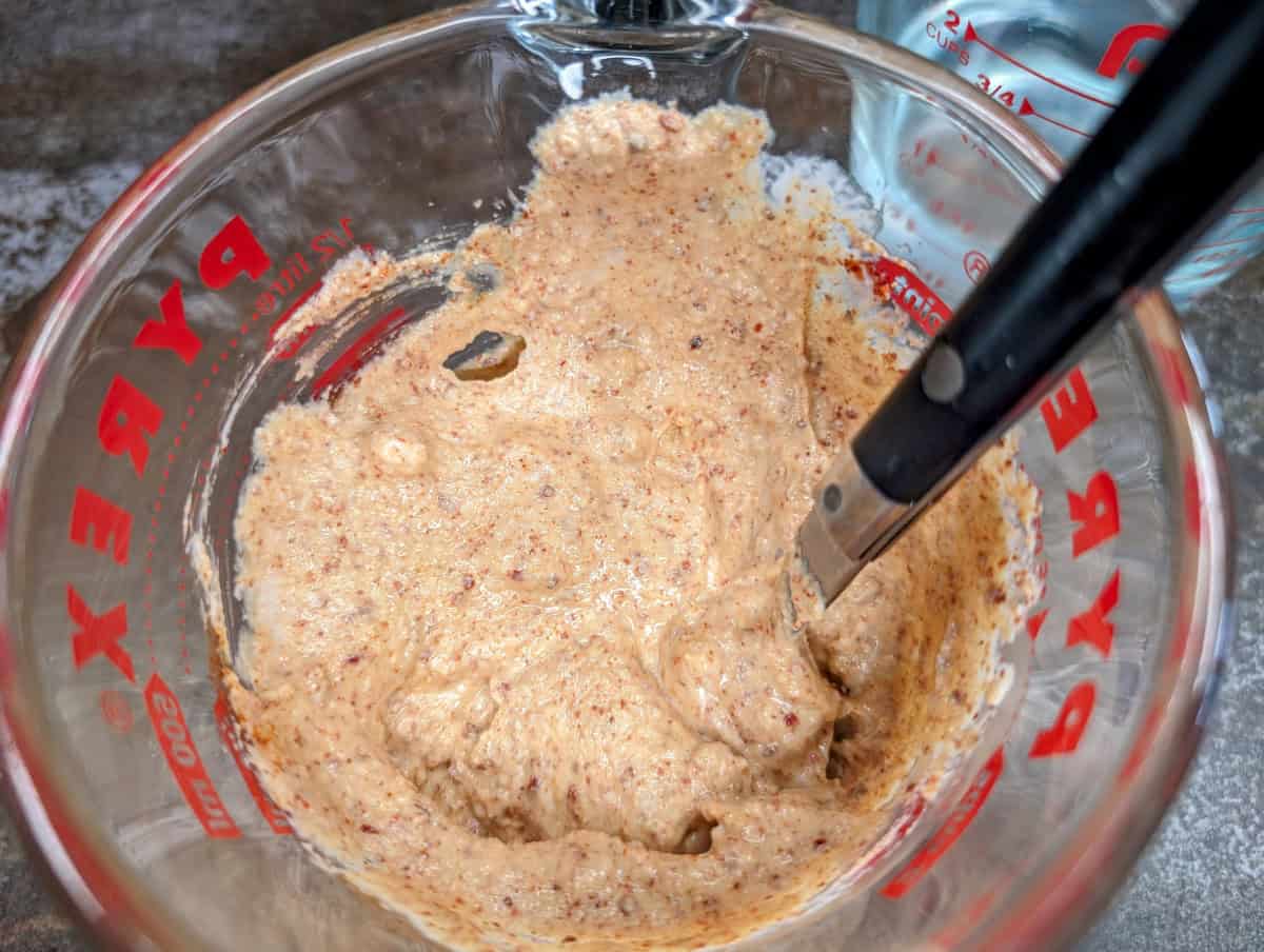 Mix the spices and garlic with the tahini and lemon juice mixture.