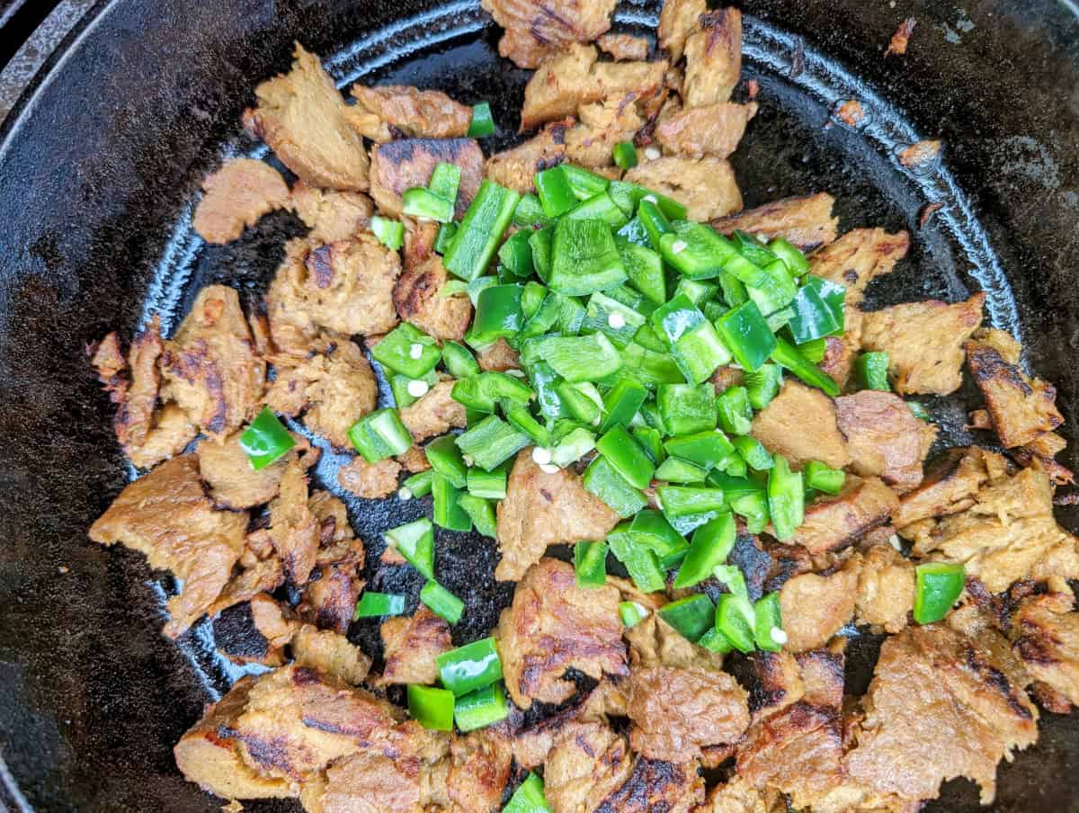 Add the chopped jalapeños to the browned seitan.