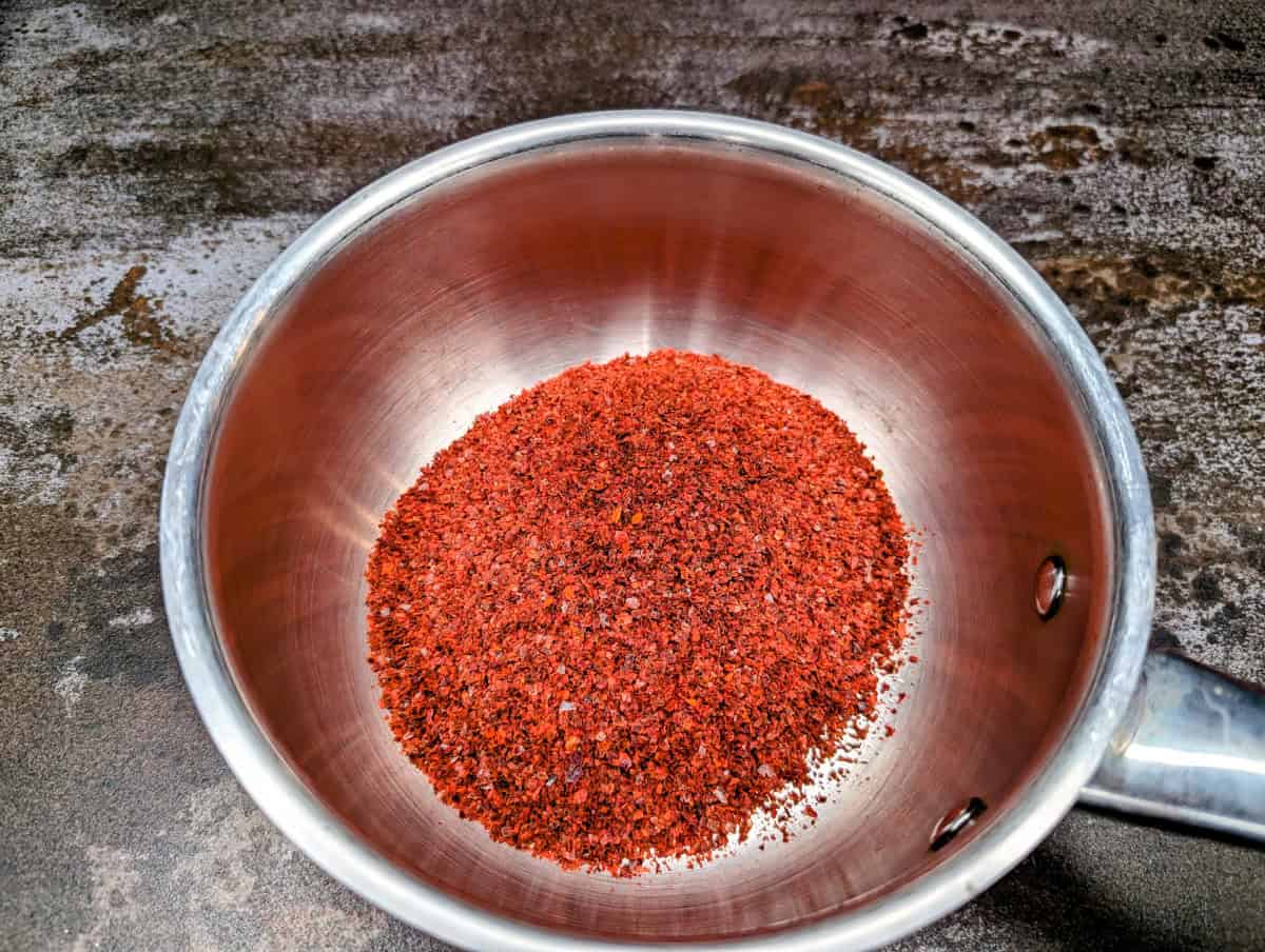 Gochujang sauce, step 1, put gochugaru or desired pepper flakes into a small saucepan.