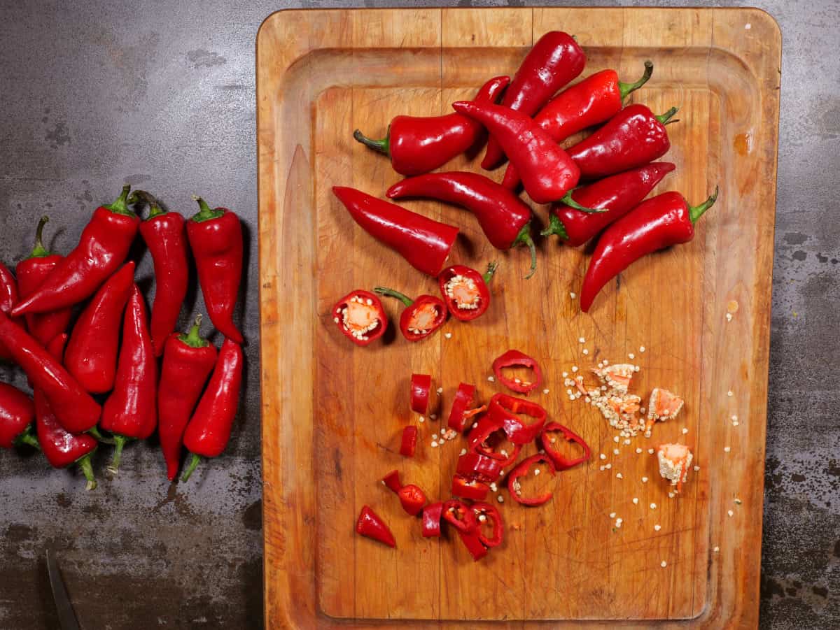 chilis on cutting board being sliced