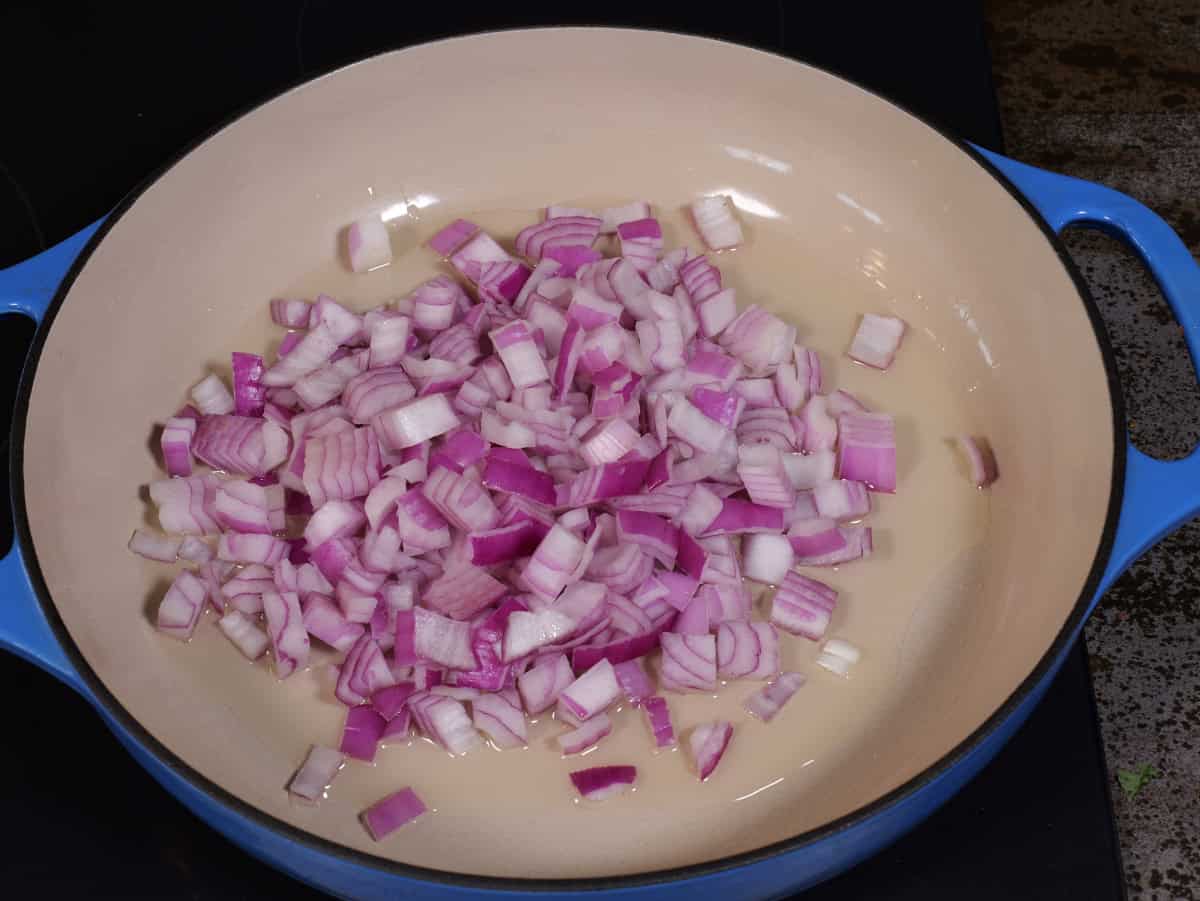 freshly chopped onions in pan with oil