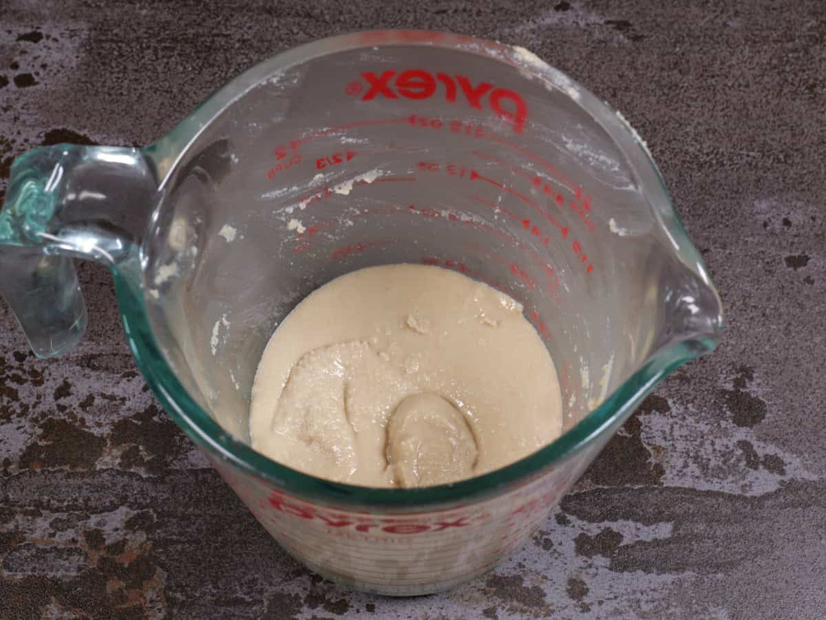 The tahini paste in the measuring cup.