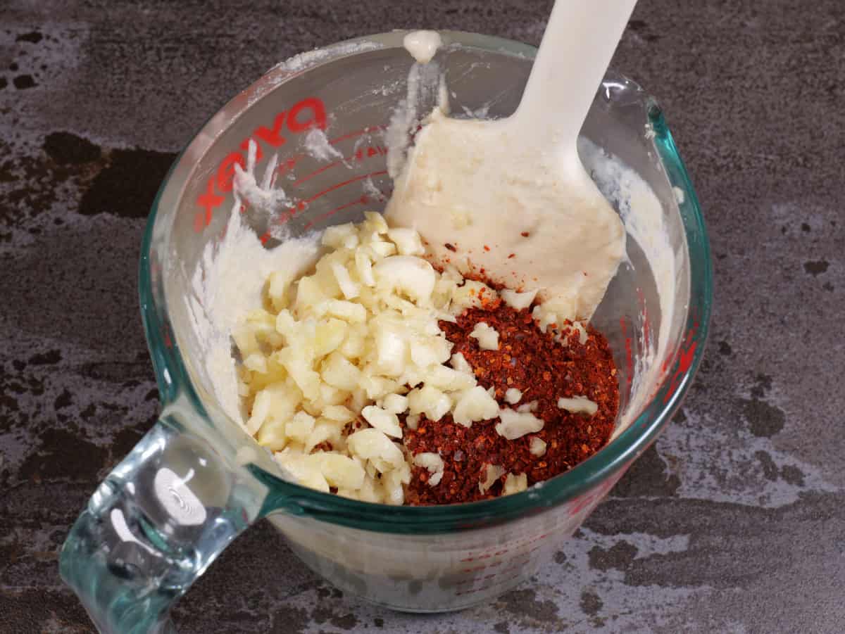 The rest of the ingredients added to the measuring up, except the water.