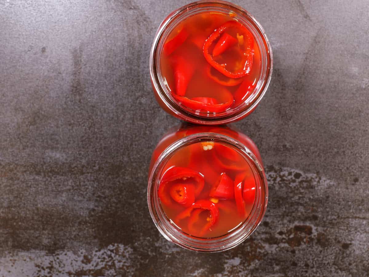 peppers and garlic in a jar, topped with the brine.