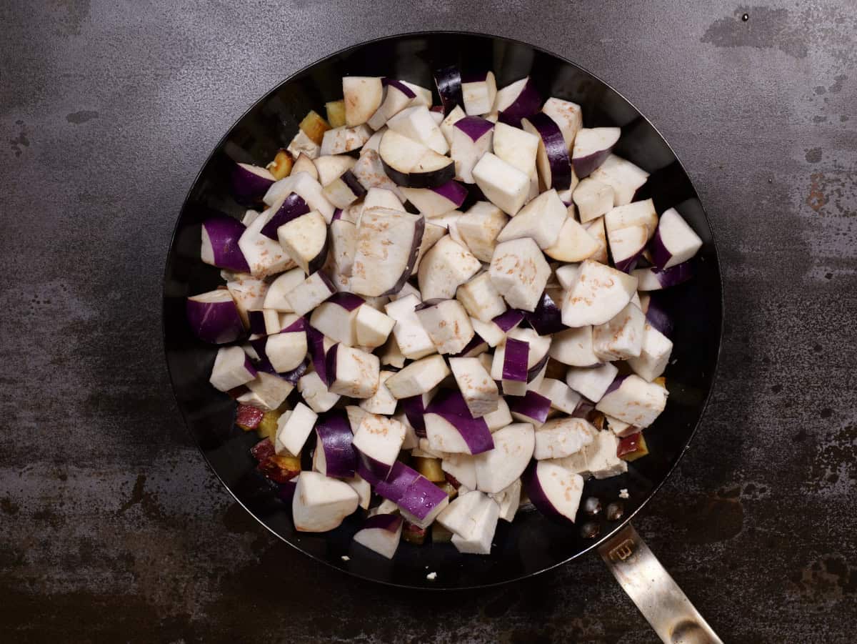 Adding the eggplant to the potatoes and tofu