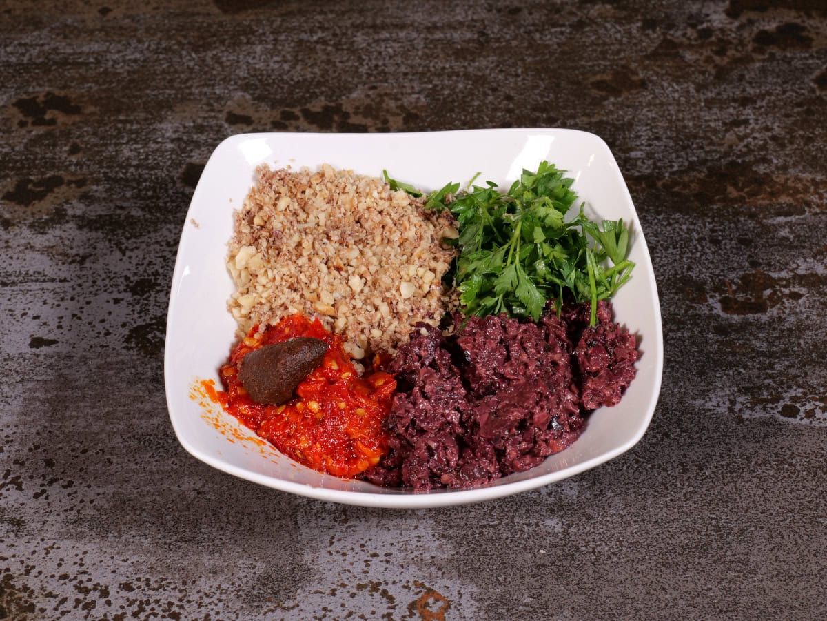 all ingredients of tapenade in a bowl, separated