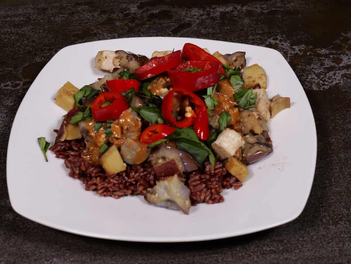 a tofu, sweet potato, eggplant scramble with peanut sauce, Thai basil and Fresno chilis