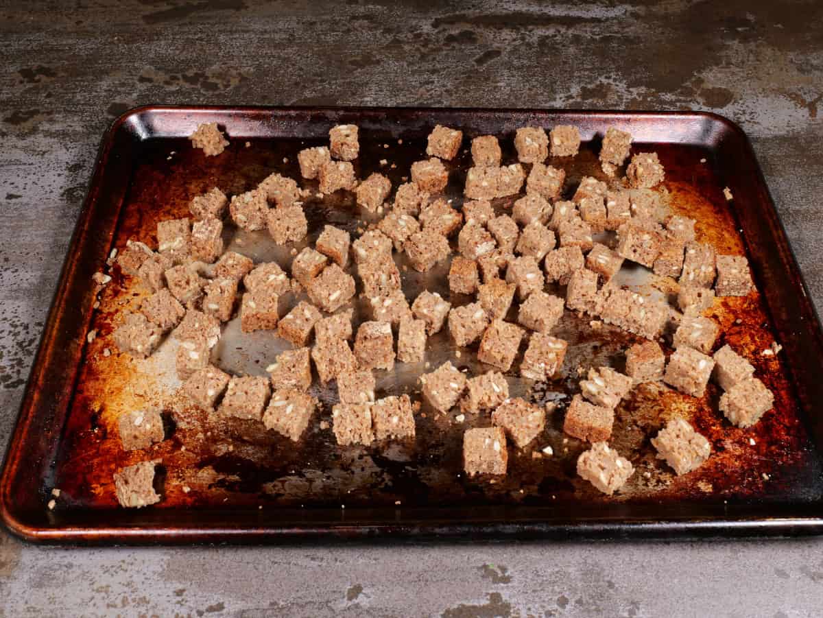 the bread cubes on the baking sheet before toasting