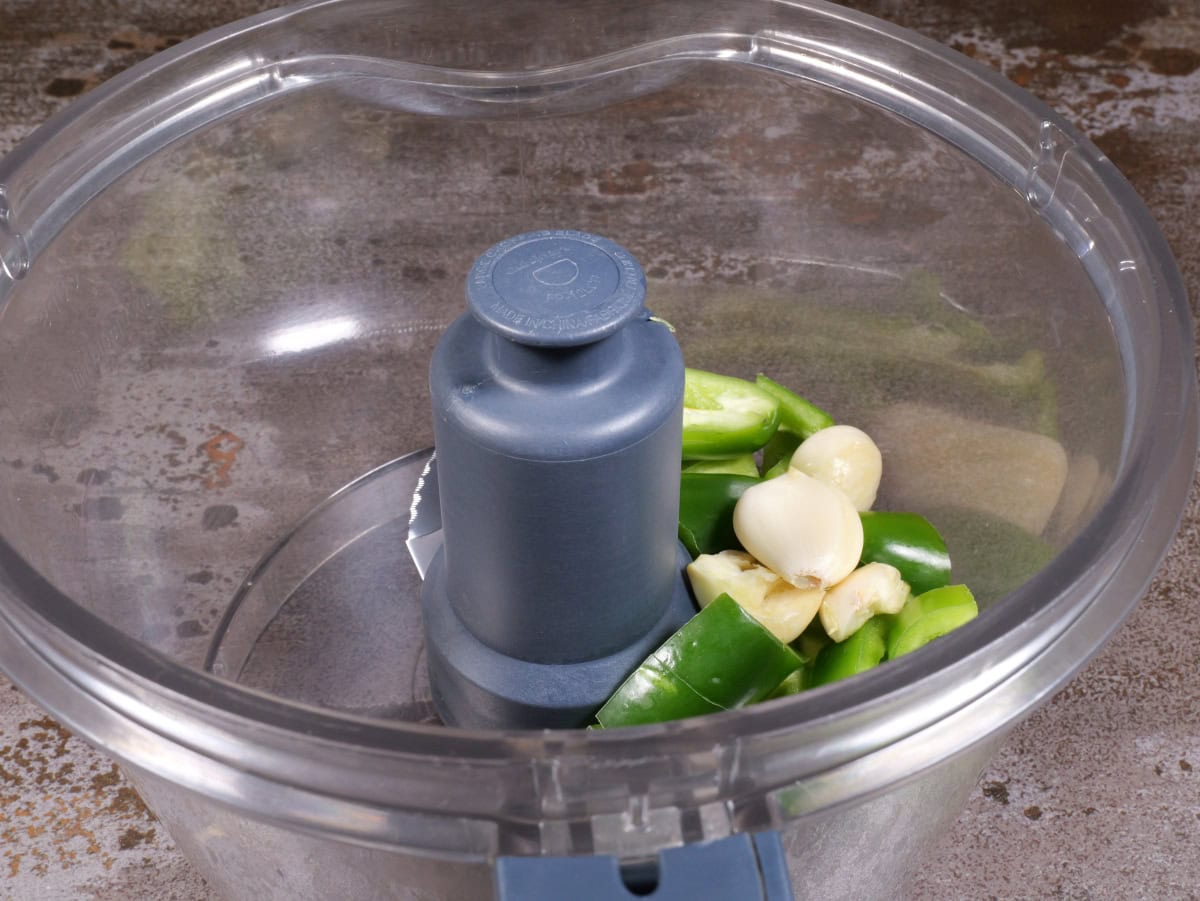 garlic and jalapeños in processor